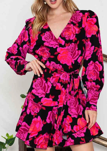 Bright pink floral, print on the black background on this cross front long sleeve mini dress