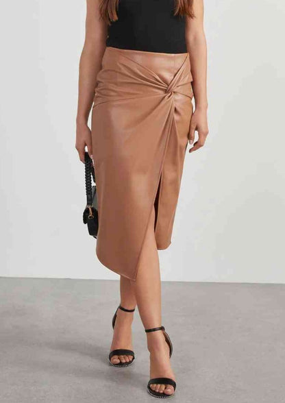 this seasons trending look: PU leather like skirt with twist top and side slit